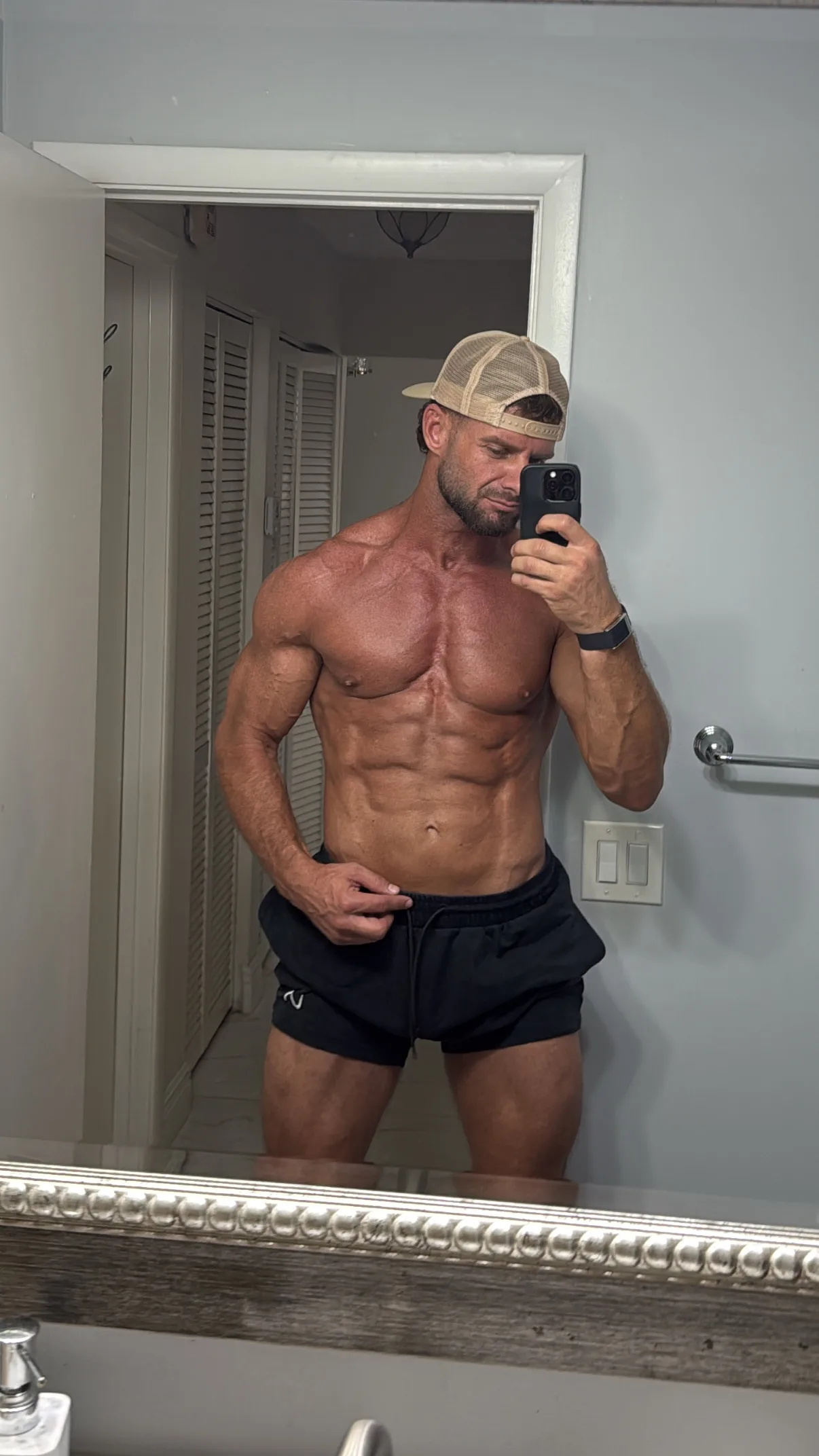 Zach’s personal progress at 14 months, in a mirror photo wearing a cap and black shorts