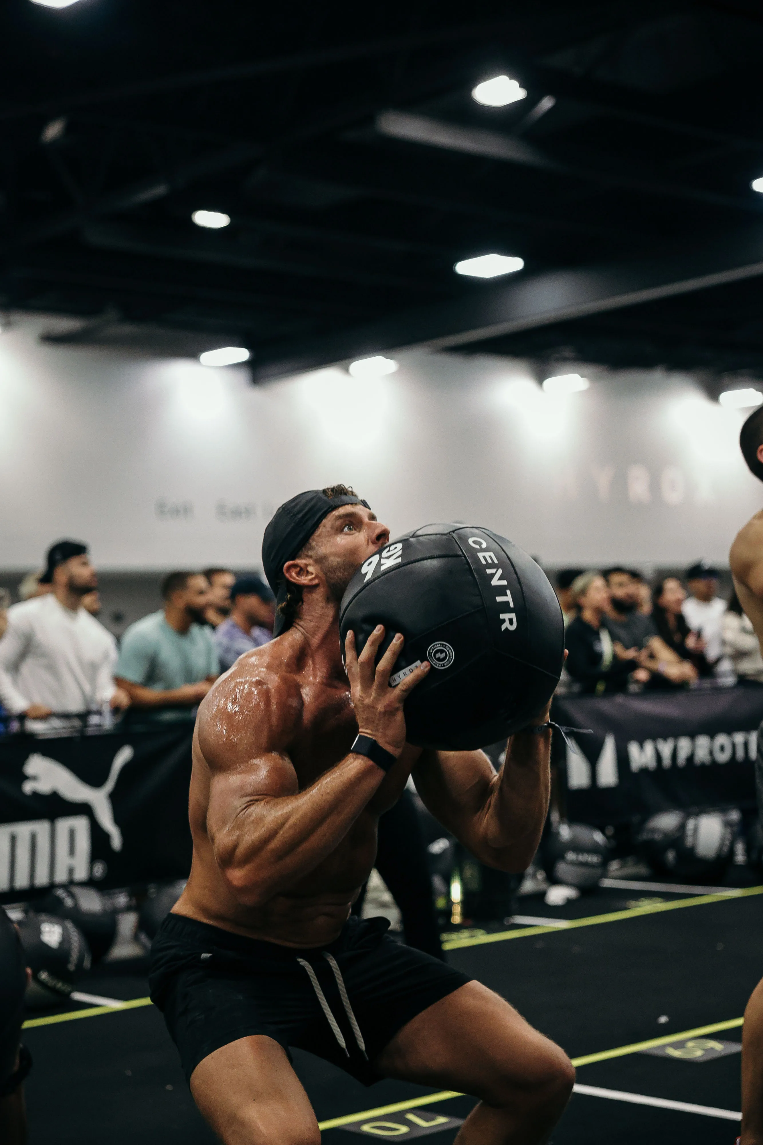 Zach at 24 months, lifting a medicine ball during a fitness event